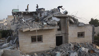 People inspect family house in West Bank village of Yatta